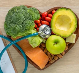 Bowl of healthy fruits and vegetables with a stethescope