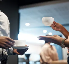 people with cups of coffee chatting