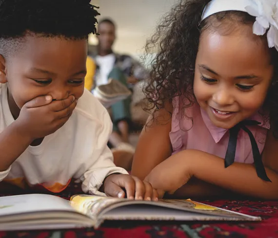 Brother and sister reading a book