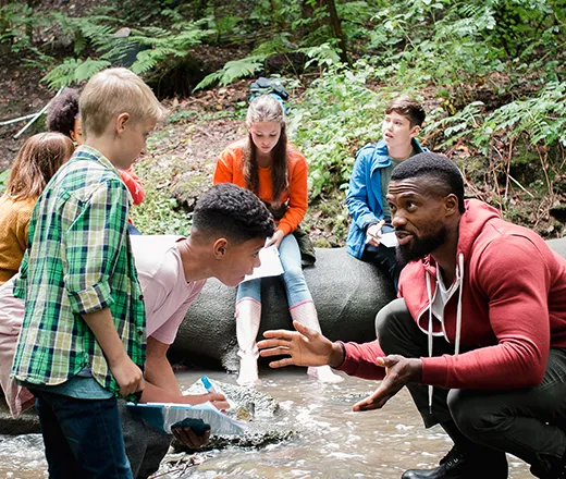 Camp counselor talking to campers